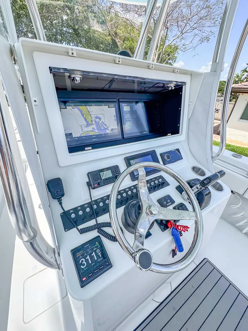 Slide: The Image of 2021 Contender 30 Tournament boat dashboard with navigation screens and controls. - 11
