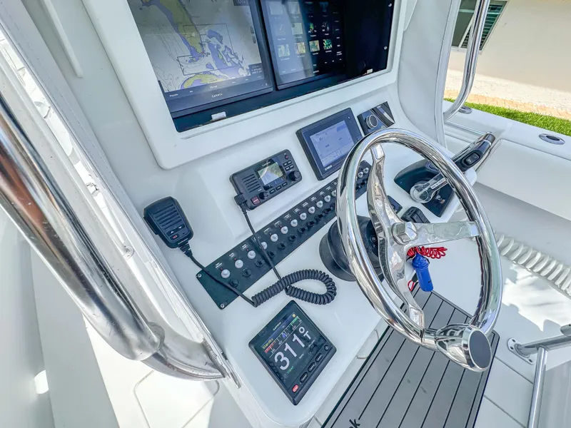 Slide: The Image of Helm of 2021 Contender 30 Tournament boat with advanced navigation and control systems. - 12