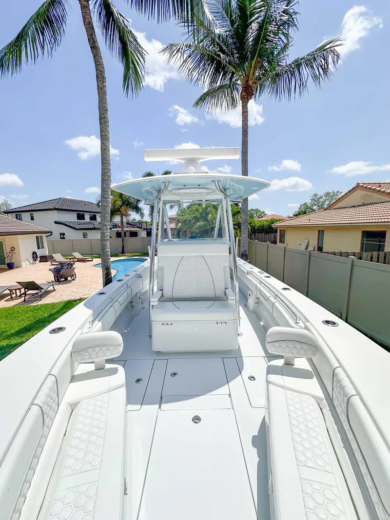 Slide: The Image of 2021 Contender 30 Tournament boat, sleek design, spacious deck, palm trees in background. - 22