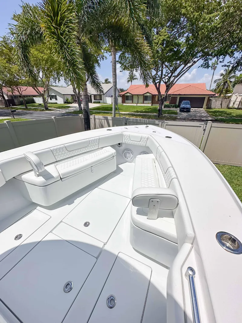 Slide: The Image of 2021 Contender 30 Tournament boat with spacious seating, set against a suburban backdrop. - 24