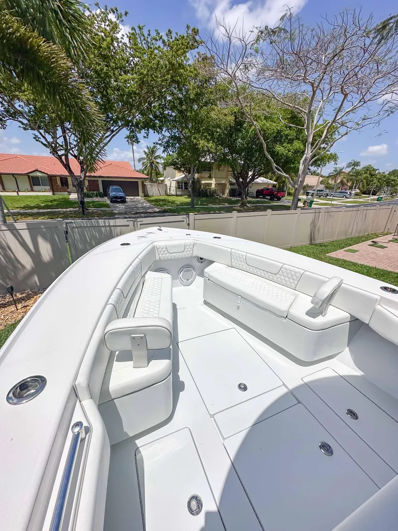 Slide: The Image of 2021 Contender 30 Tournament boat with spacious seating, set outdoors under a clear sky. - 25