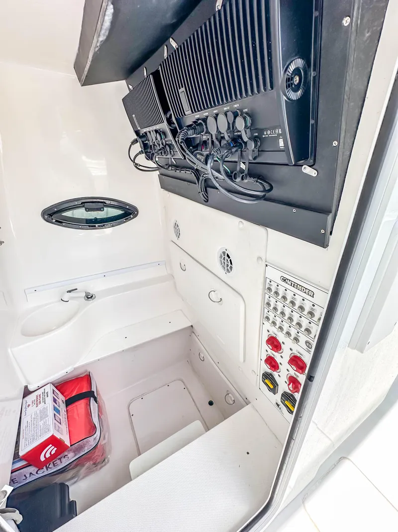 Slide: The Image of 2021 Contender 30 Tournament boat interior with control panel and storage area. - 29