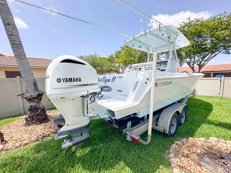 Slide: The Image of 2021 Contender 30 Tournament boat with Yamaha engine on a trailer, parked on grass. - 3