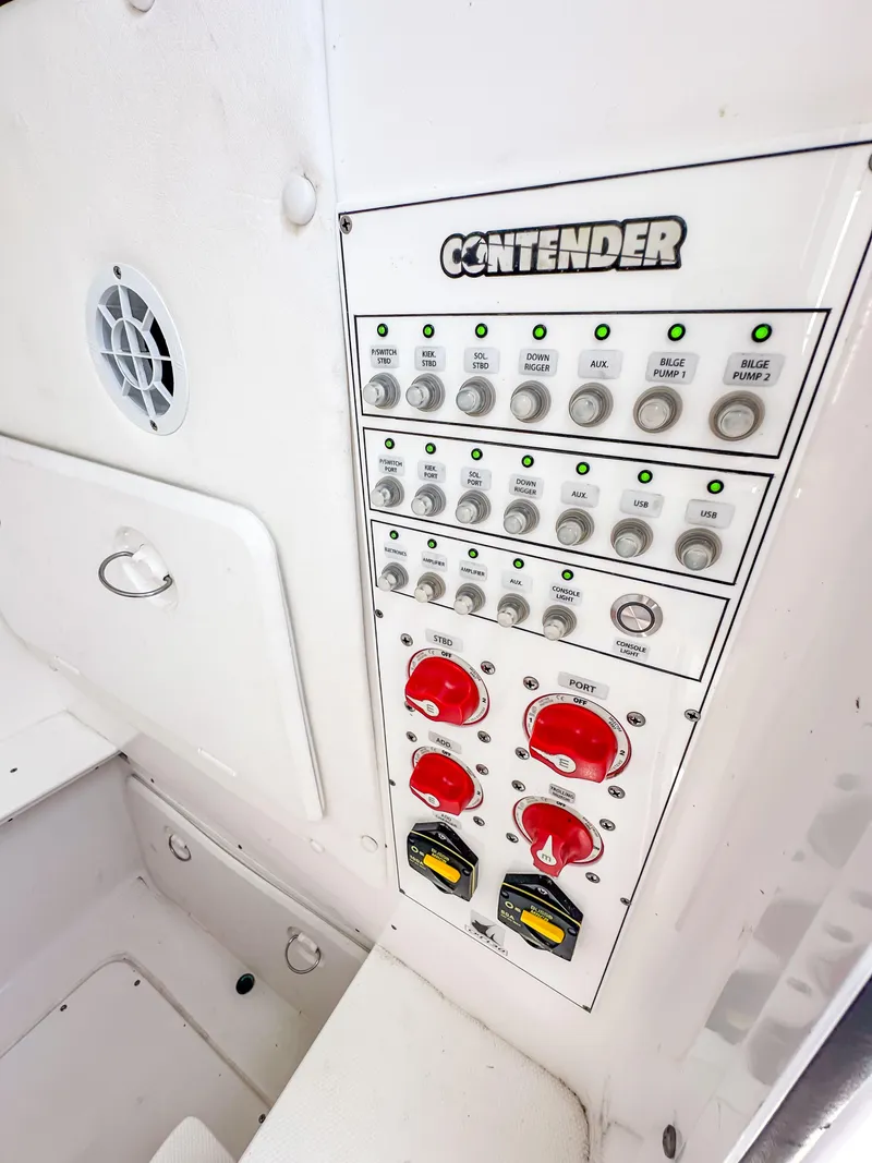 Slide: The Image of Control panel of a 2021 Contender 30 Tournament boat with various switches and indicators. - 30
