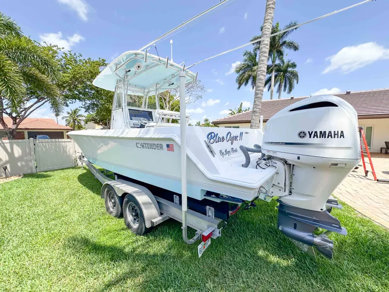 Slide: The Image of 2021 Contender 30 Tournament boat with Yamaha engine on trailer, parked on grass. - 5