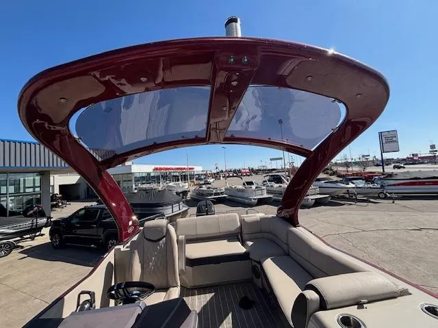 Slide: The Image of 2018 Harris Crowne SL 250 pontoon boat with spacious seating and sleek design at a marina. - 10