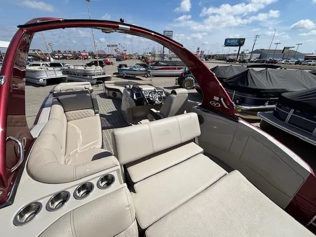 Slide: The Image of 2018 Harris Crowne SL 250 boat with luxurious seating and modern dashboard, docked under a sunny sky. - 14