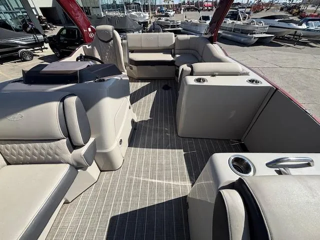 Slide: The Image of 2018 Harris Crowne SL 250 pontoon boat interior with luxurious seating and cup holders. - 16