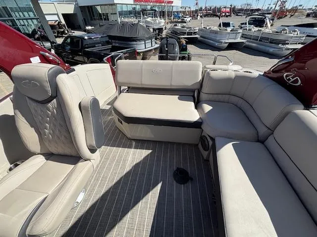 Slide: The Image of 2018 Harris Crowne SL 250 boat interior with beige seating and spacious layout. - 20