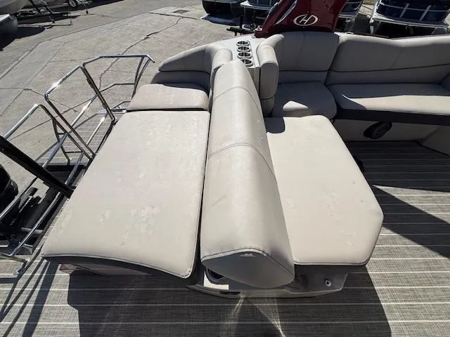 Slide: The Image of 2018 Harris Crowne SL 250 boat with beige seating and cup holders on deck. - 23