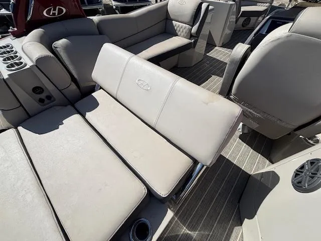 Slide: The Image of 2018 Harris Crowne SL 250 boat interior with beige seating and cup holders. - 25