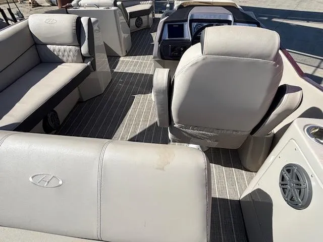 Slide: The Image of 2018 Harris Crowne SL 250 boat interior with beige seating and modern dashboard. - 29