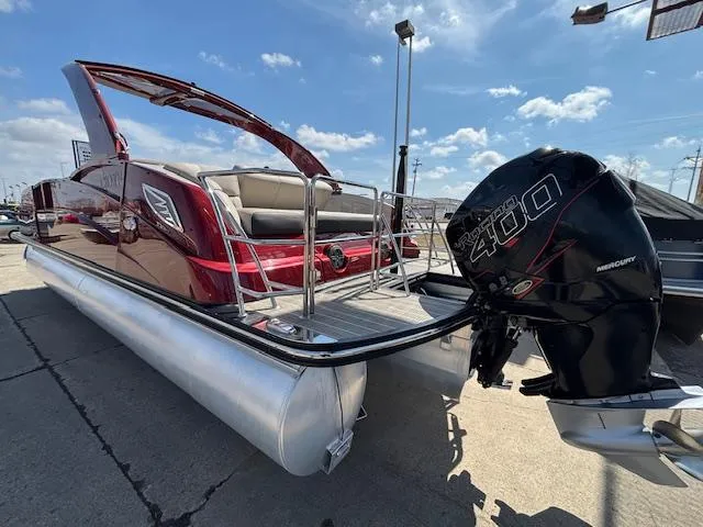 Slide: The Image of 2018 Harris Crowne SL 250 pontoon boat with Mercury 400 engine, docked under blue sky. - 3