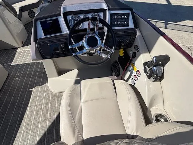 Slide: The Image of 2018 Harris Crowne SL 250 boat cockpit with steering wheel and control panel. - 30