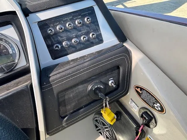 Slide: The Image of Control panel of a 2018 Harris Crowne SL 250 boat with ignition and switches. - 32