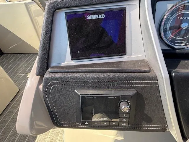 Slide: The Image of Dashboard of 2018 Harris Crowne SL 250 with Simrad display and JL Audio system. - 34