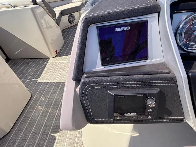 Slide: The Image of 2018 Harris Crowne SL 250 dashboard with Simrad display and audio controls. - 37