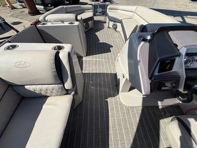 Slide: The Image of 2018 Harris Crowne SL 250 boat interior with luxurious seating and modern dashboard. - 38