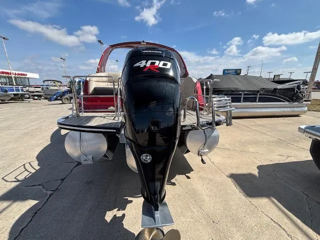 Slide: The Image of 2018 Harris Crowne SL 250 pontoon boat with powerful 400R engine, docked under a clear sky. - 4