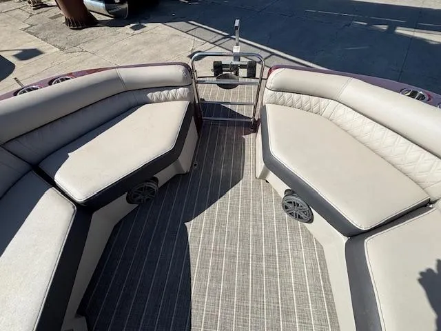 Slide: The Image of 2018 Harris Crowne SL 250 boat interior with cushioned seating and speakers. - 42