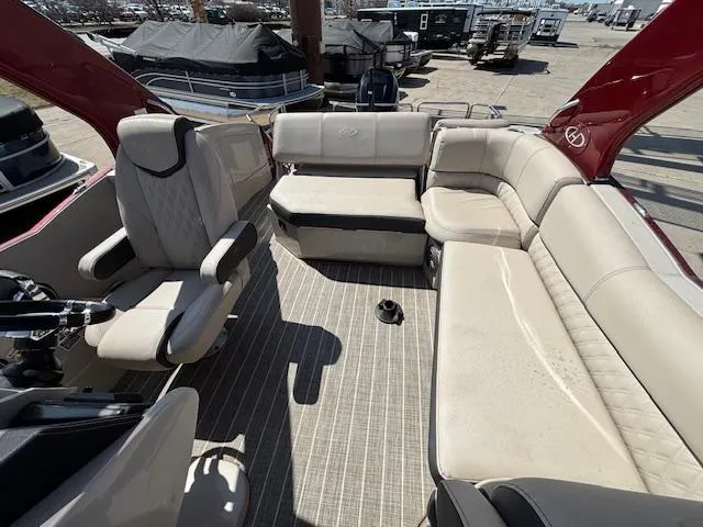 Slide: The Image of 2018 Harris Crowne SL 250 boat interior with beige seating and striped flooring. - 46