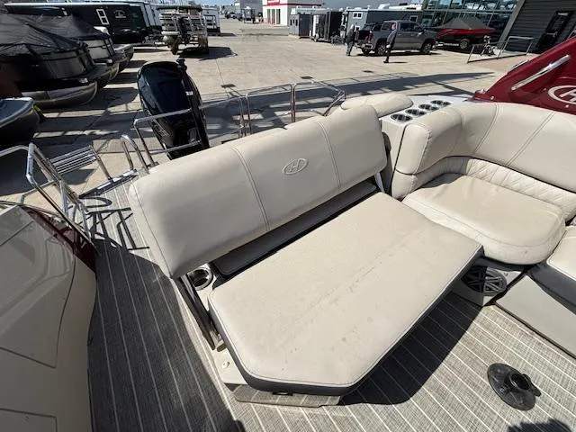 Slide: The Image of 2018 Harris Crowne SL 250 boat interior with beige seating and cup holders. - 48