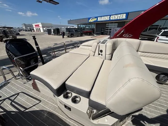 Slide: The Image of 2018 Harris Crowne SL 250 boat with beige seating at a marine center. - 49