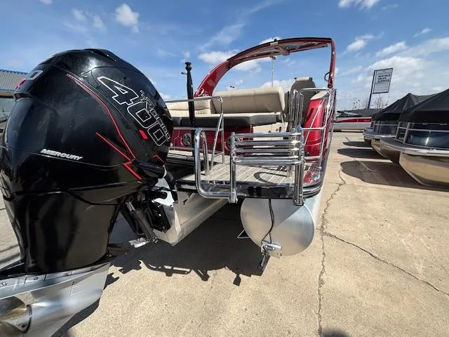 Slide: The Image of 2018 Harris Crowne SL 250 pontoon boat with Mercury 400 engine, docked under clear skies. - 5