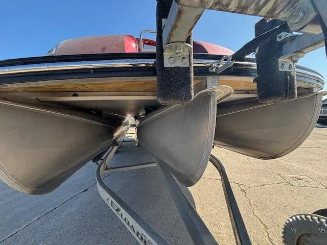 Slide: The Image of 2018 Harris Crowne SL 250 pontoon boat on trailer, viewed from below. - 9