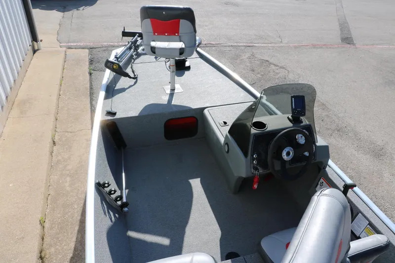 Slide: The Image of 2016 Tracker Pro 160 boat interior with steering console and seating. - 12