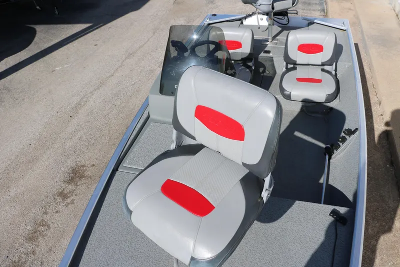 Slide: The Image of 2016 Tracker Pro 160 boat interior with gray and red seating. - 14
