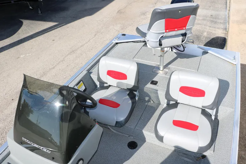 Slide: The Image of 2016 Tracker Pro 160 boat interior with three gray and red seats. - 15
