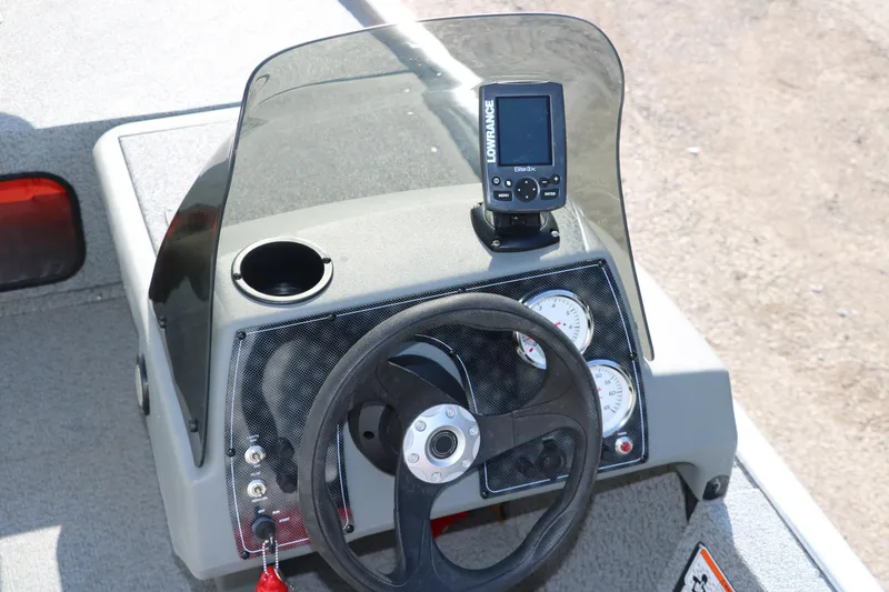 Slide: The Image of 2016 Tracker Pro 160 boat dashboard with steering wheel and navigation system. - 16