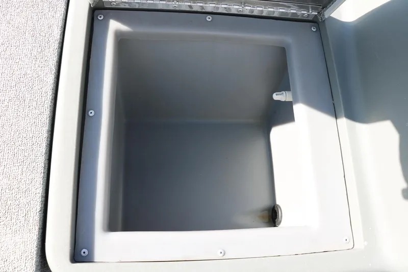 Slide: The Image of Open storage compartment in 2016 Tracker Pro 160 boat. - 18