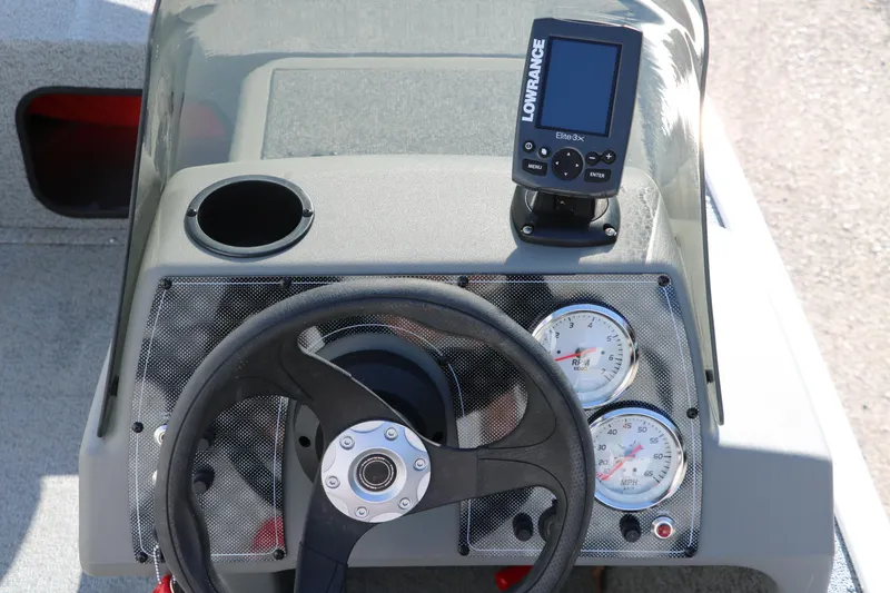 Slide: The Image of 2016 Tracker Pro 160 dashboard with steering wheel, gauges, and Lowrance fish finder. - 19