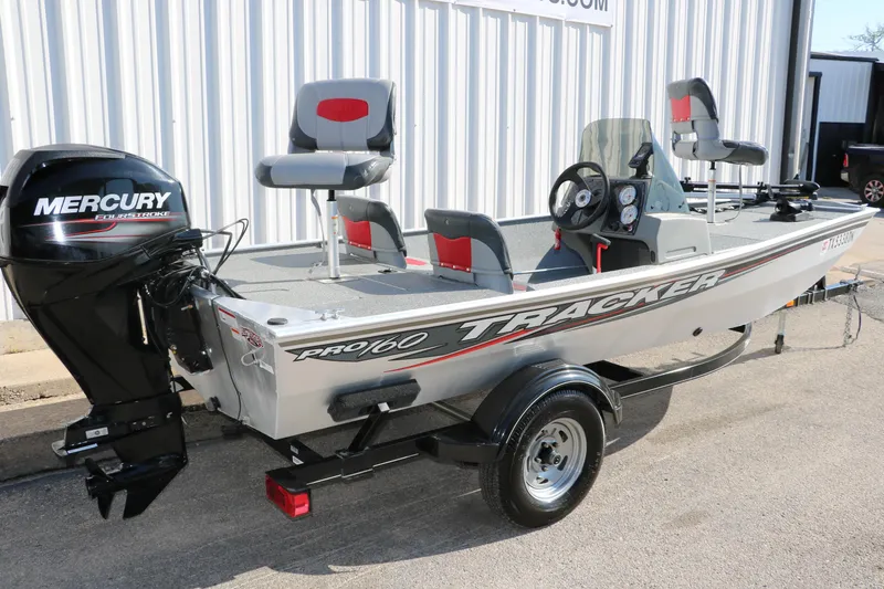 Slide: The Image of 2016 Tracker Pro 160 boat with Mercury outboard motor, parked on a trailer. - 3