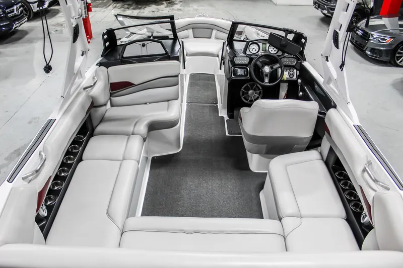 Slide: The Image of 2018 Axis A22 boat interior with spacious seating and modern dashboard. - 10