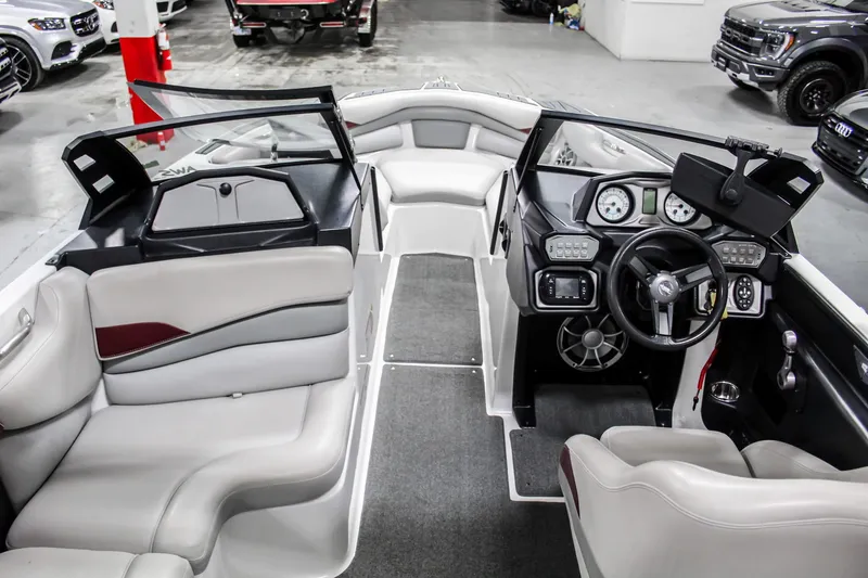 Slide: The Image of 2018 Axis A22 boat interior with modern dashboard and seating. - 12