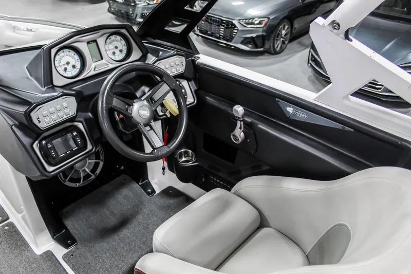 Slide: The Image of 2018 Axis A22 boat interior with steering wheel and dashboard controls. - 13