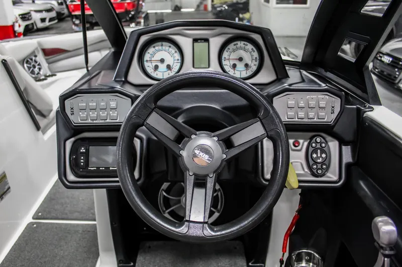 Slide: The Image of 2018 Axis A22 boat dashboard with steering wheel, gauges, and control panels. - 14