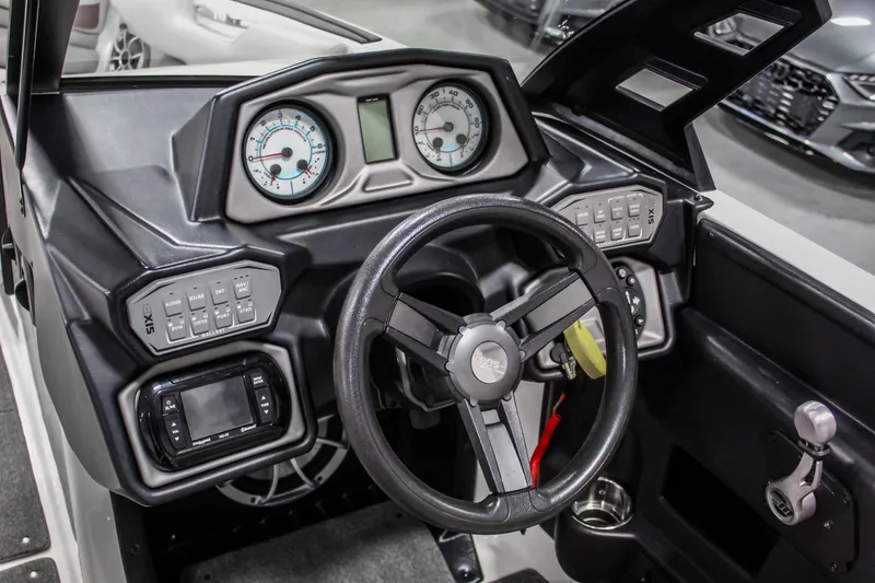 Slide: The Image of 2018 Axis A22 boat dashboard with steering wheel, gauges, and control panels. - 15