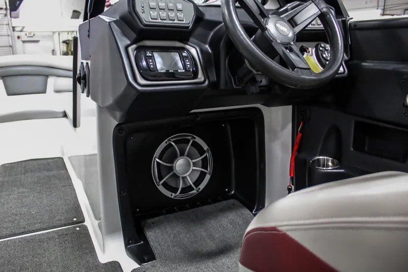 Slide: The Image of 2018 Axis A22 boat interior with steering wheel, dashboard, and speaker system. - 17
