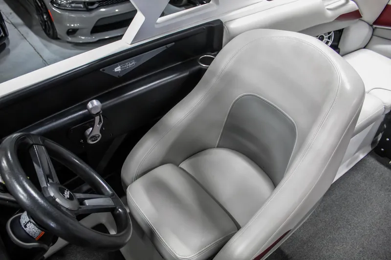 Slide: The Image of 2018 Axis A22 boat interior with gray captain's seat and steering wheel. - 18
