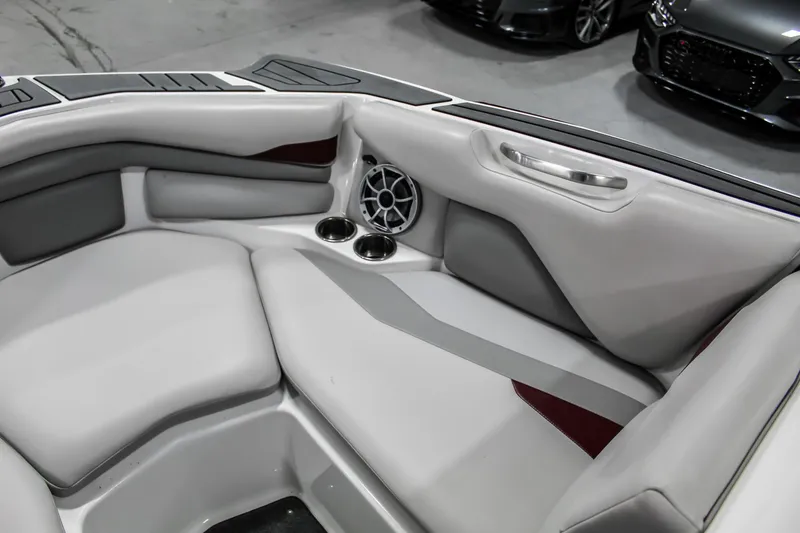Slide: The Image of Interior of a 2018 Axis A22 boat with gray seating and cup holders. - 21