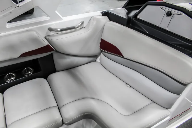 Slide: The Image of 2018 Axis A22 boat interior with gray and red cushioned seating. - 24