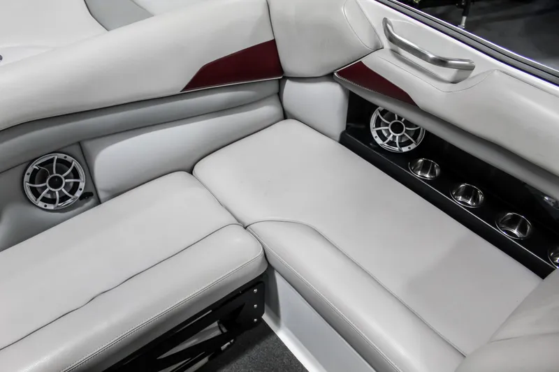Slide: The Image of 2018 Axis A22 boat interior with gray seating and built-in speakers. - 27