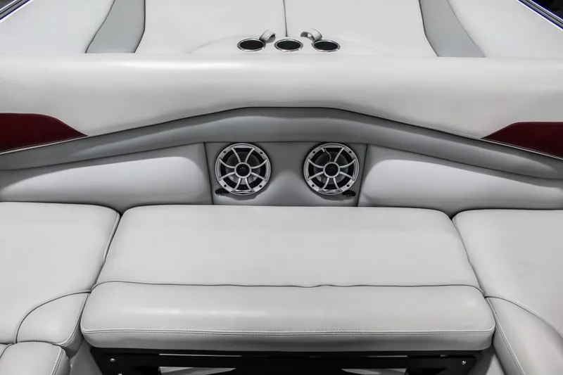 Slide: The Image of 2018 Axis A22 boat interior with white seating and built-in speakers. - 31