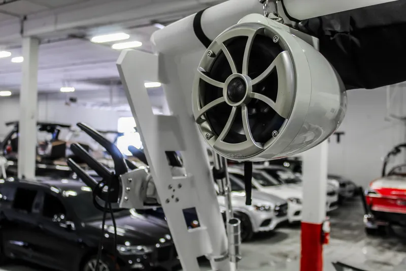 Slide: The Image of 2018 Axis A22 boat speaker in a showroom with cars in the background. - 32