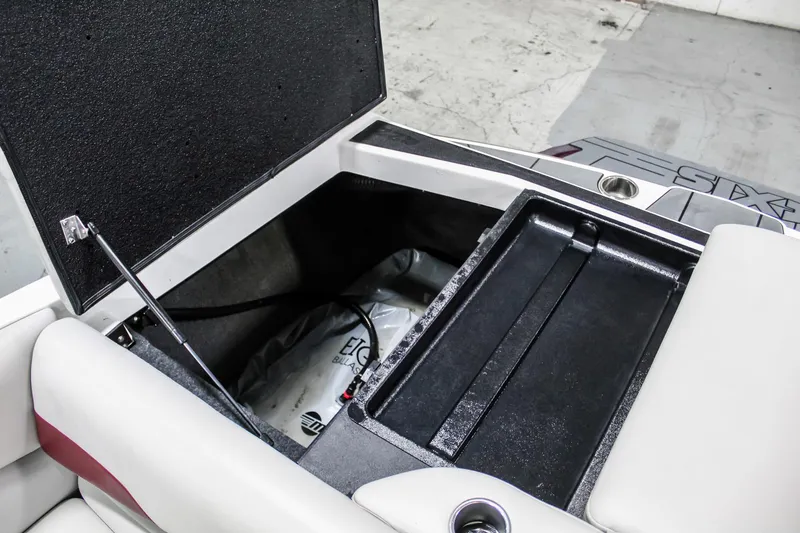 Slide: The Image of 2018 Axis A22 boat storage compartment with open lid, showcasing interior space and seating. - 34