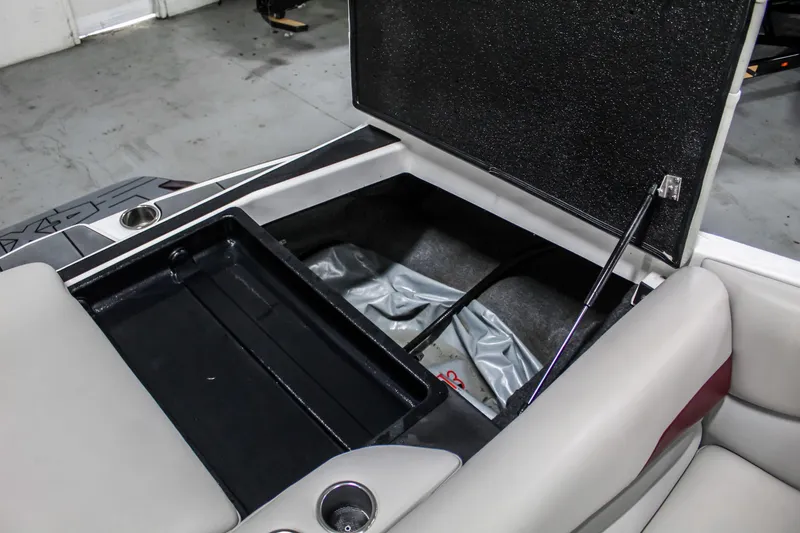 Slide: The Image of 2018 Axis A22 boat storage compartment with open lid, showcasing interior space and seating. - 35